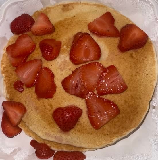 Two Pancakes with Strawberries and Whipped Cream.